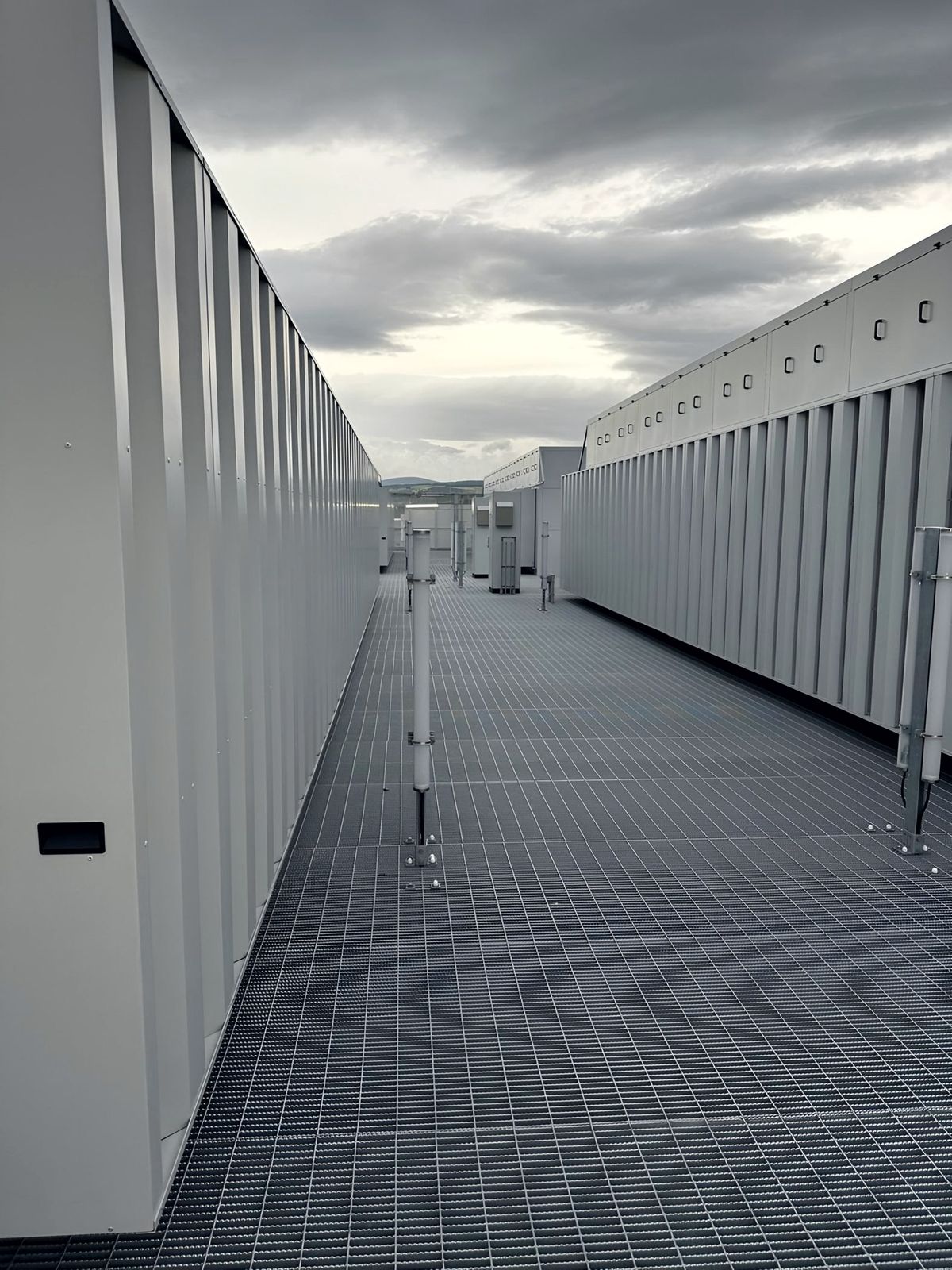 Rooftop plant deck of a hyperscale data centre with rows of electrical enclosures