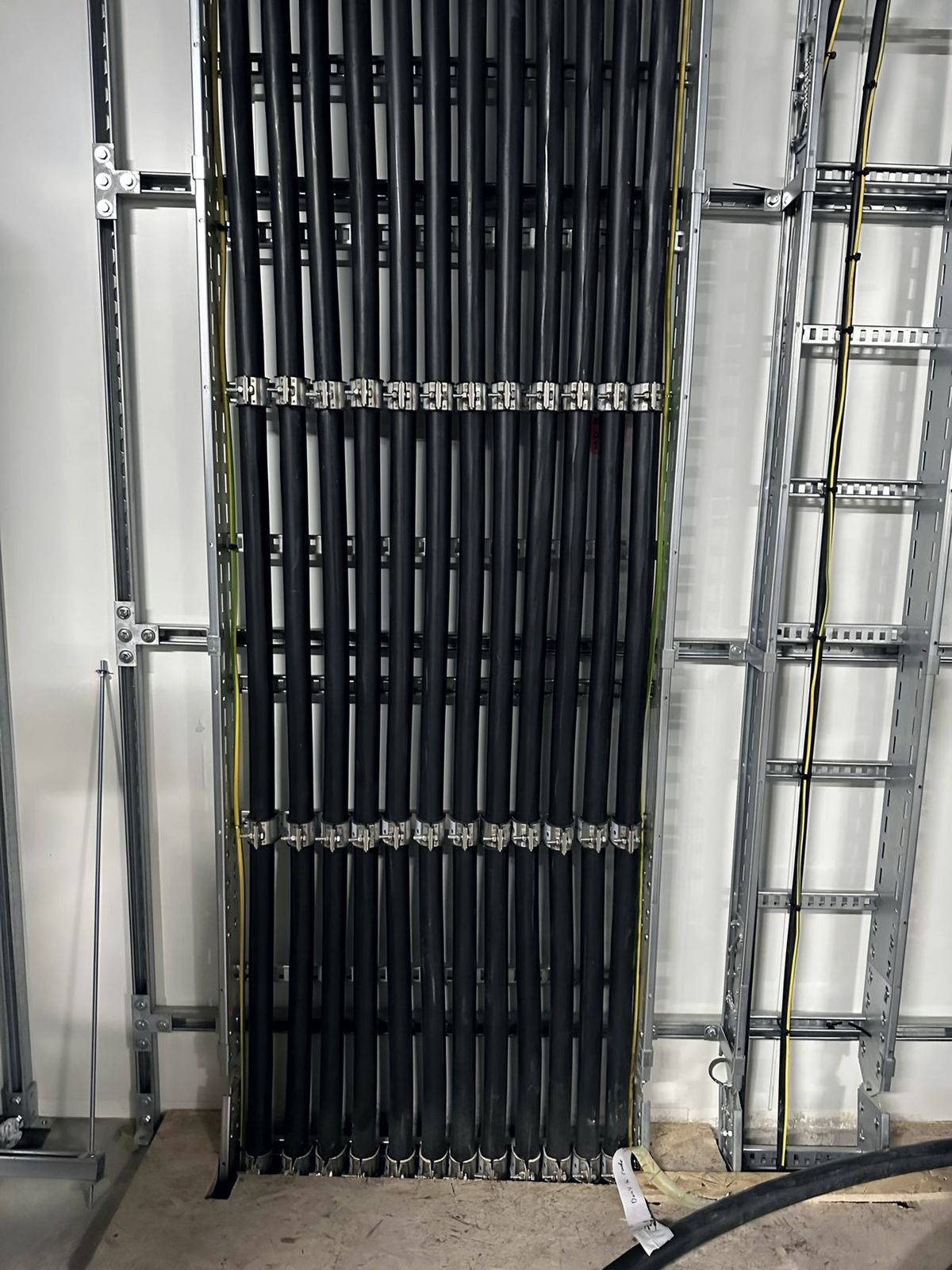Vertical cable riser with dressed power cables on ladder rack
