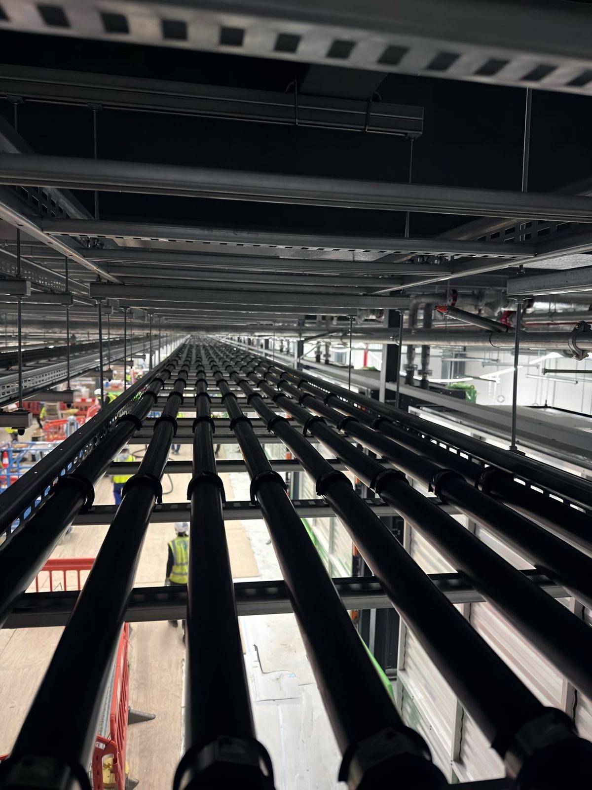 Long run of large power cables on cable ladder through a plant corridor